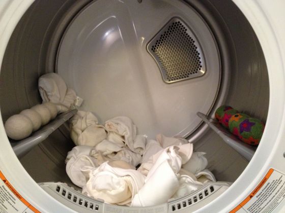 Dryer balls hanging out in my dryer with my GroVia soaker pads and fleece liners.